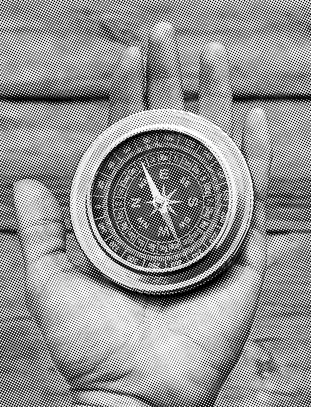 Hand holding a compass